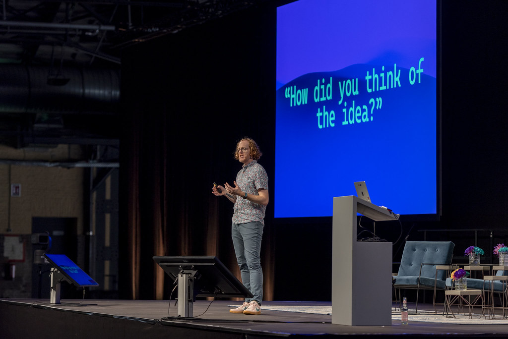 Robby Russell speaking on stage at The MERGE in Berlin, 2024